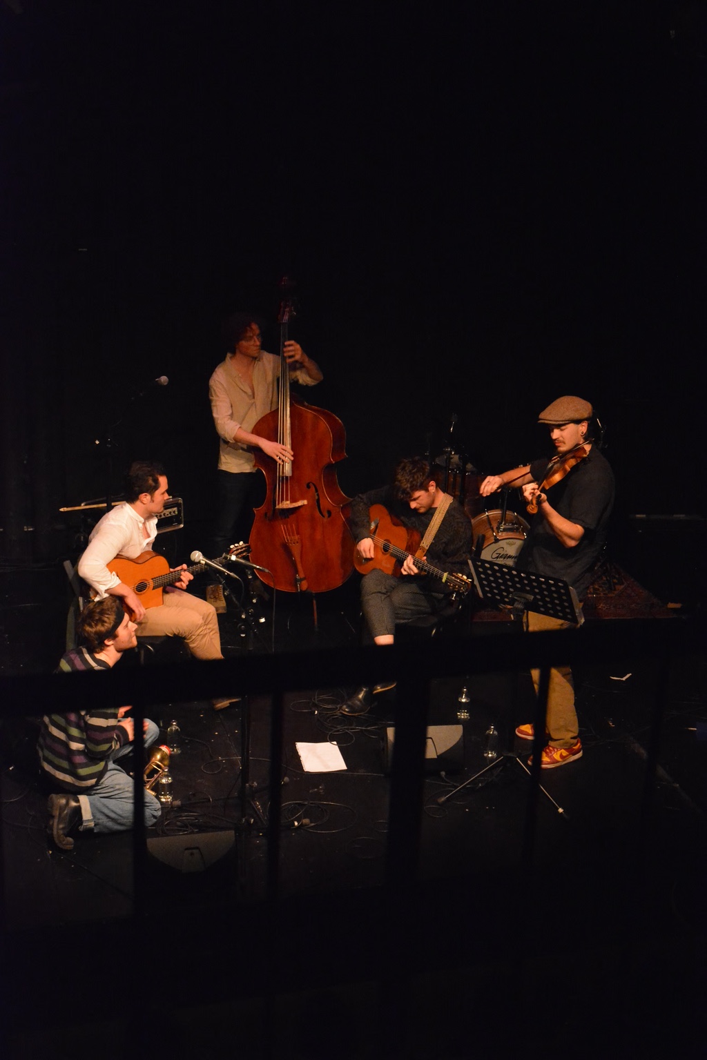 Band performing together on stage.