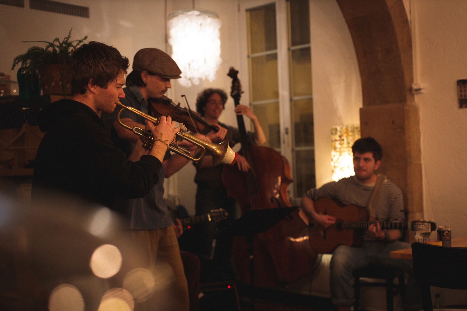 Warm live setting with band performing.